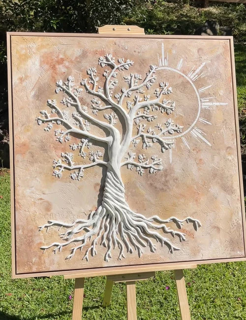 Textured artwork tree sculpture on a wooden easel outdoors