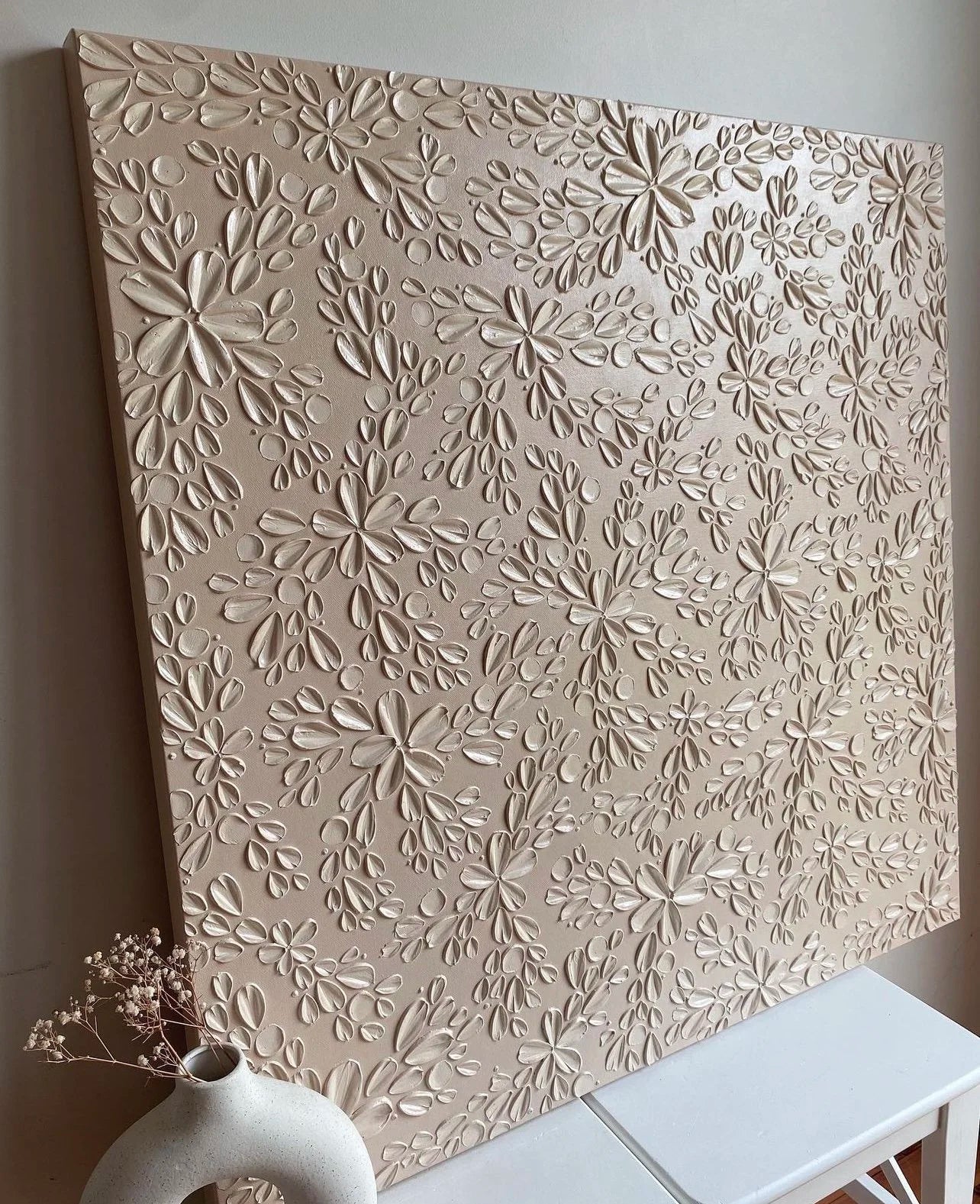 Decorative wall panel with floral pattern on a white surface