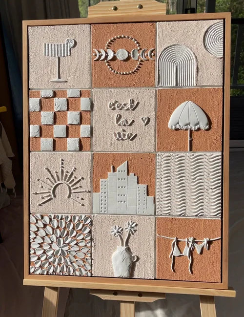 Textured artwork with various textured patterns on an easel.