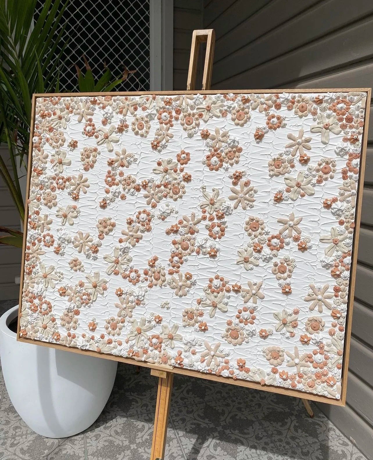 Floral patterned board on an easel outdoors