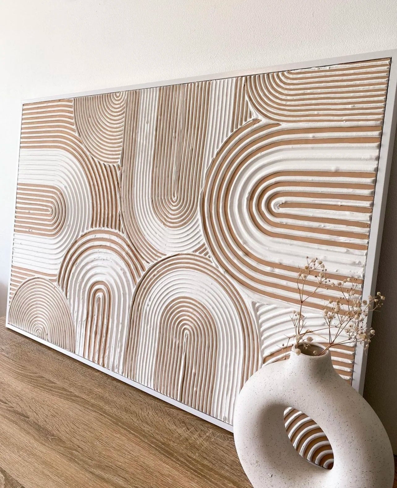 Decorative wall art with wavy patterns on a plain background